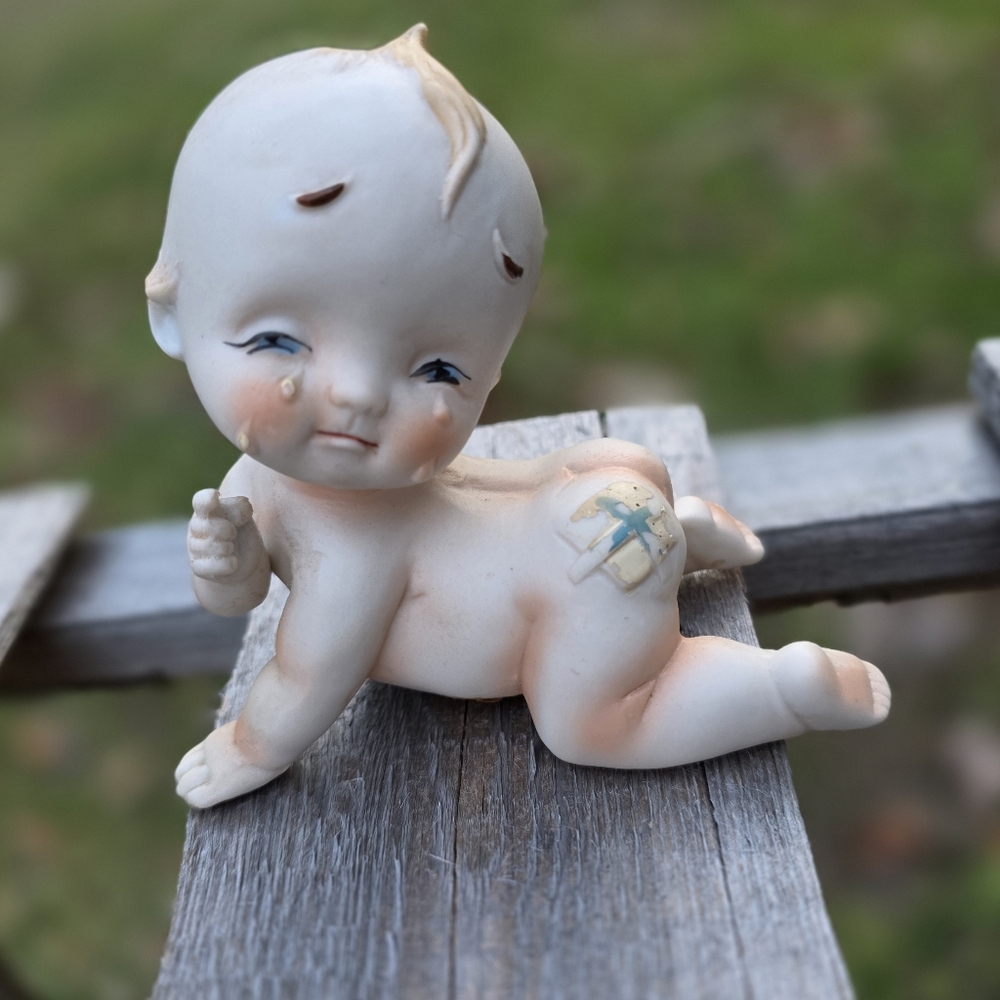 Vintage Lefton Bisque Crying Kewpie Doll With bandage On Bottom 3.5” T x 4.25” W